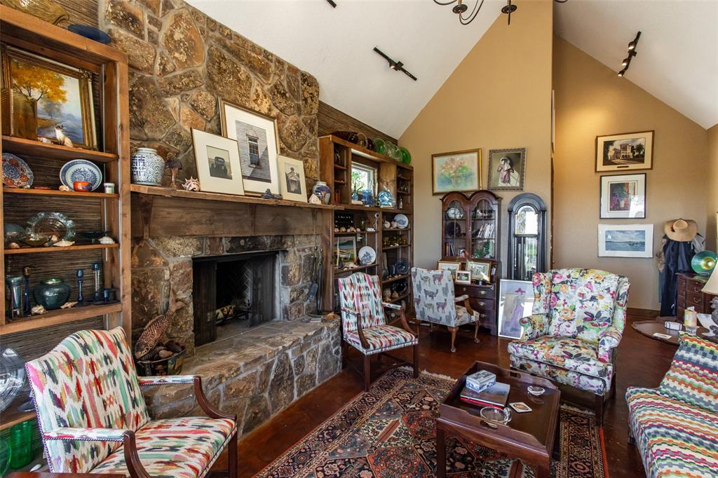 1775 Sunset Mountain Road Lipan, TX 76462 - Photo 9 of 34 a living room with furniture fireplace and a flat screen tv