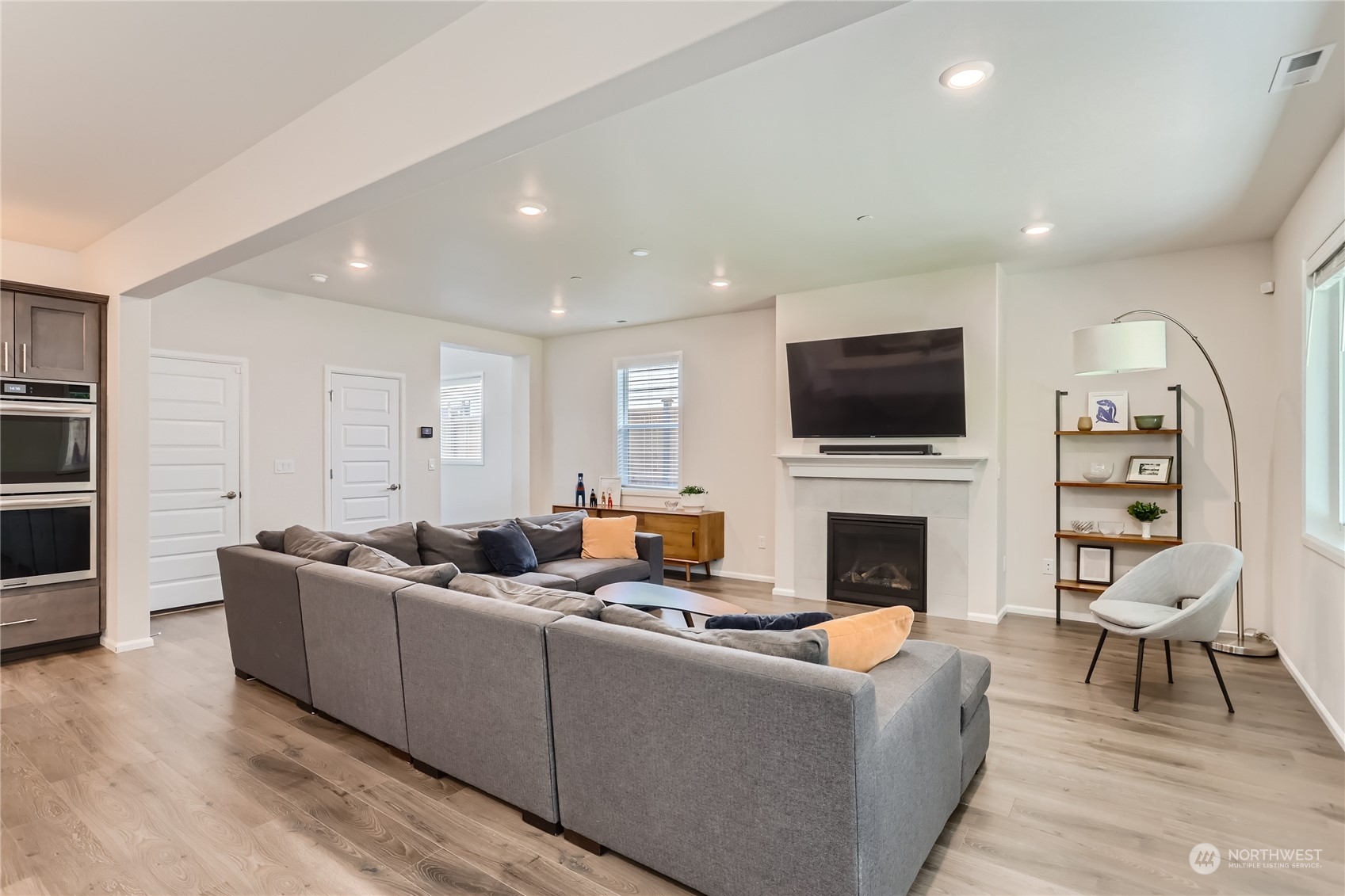 4126 235th Place Southeast Bothell, WA 98021 - Photo 9 of 28 a living room with furniture a fireplace and a flat screen tv