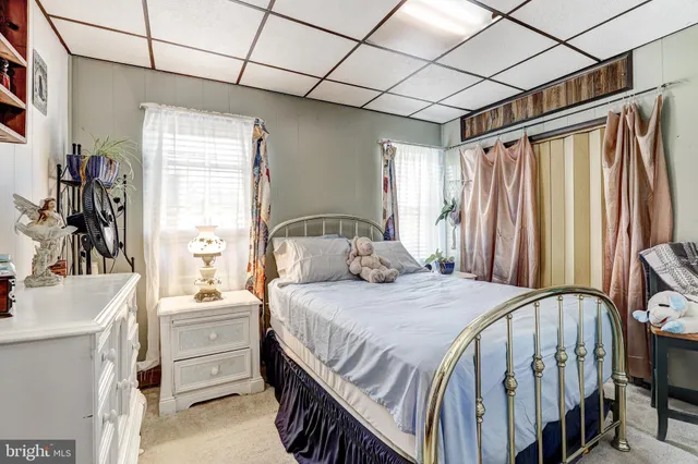 a bedroom with a bed next to a large window with the outer view