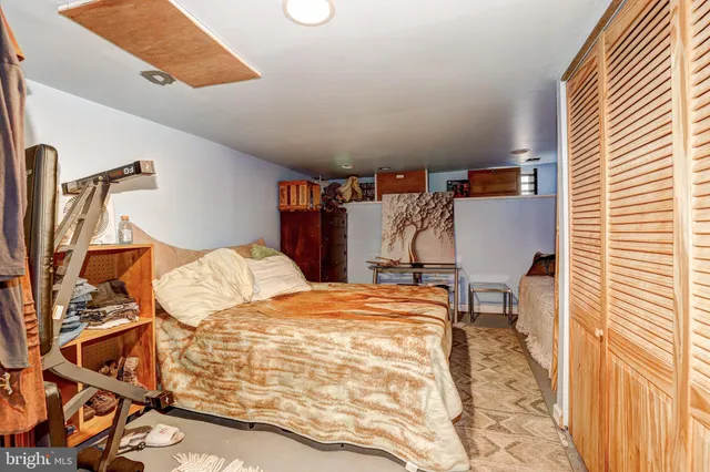 a bedroom with a bed and a closet