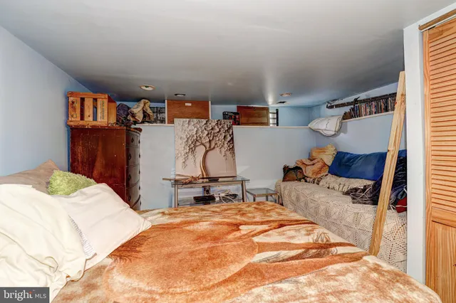 a bedroom with a bed and a couch