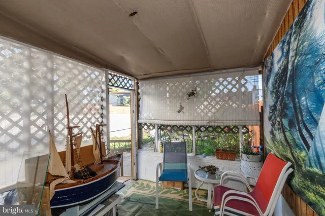 a outdoor living space with furniture and a painting