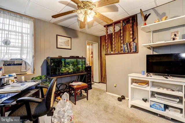 a view of a livingroom with furniture and a flat screen tv