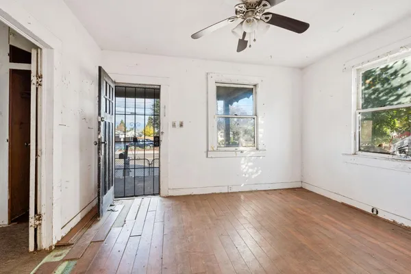 wooden floor in an empty room with a window