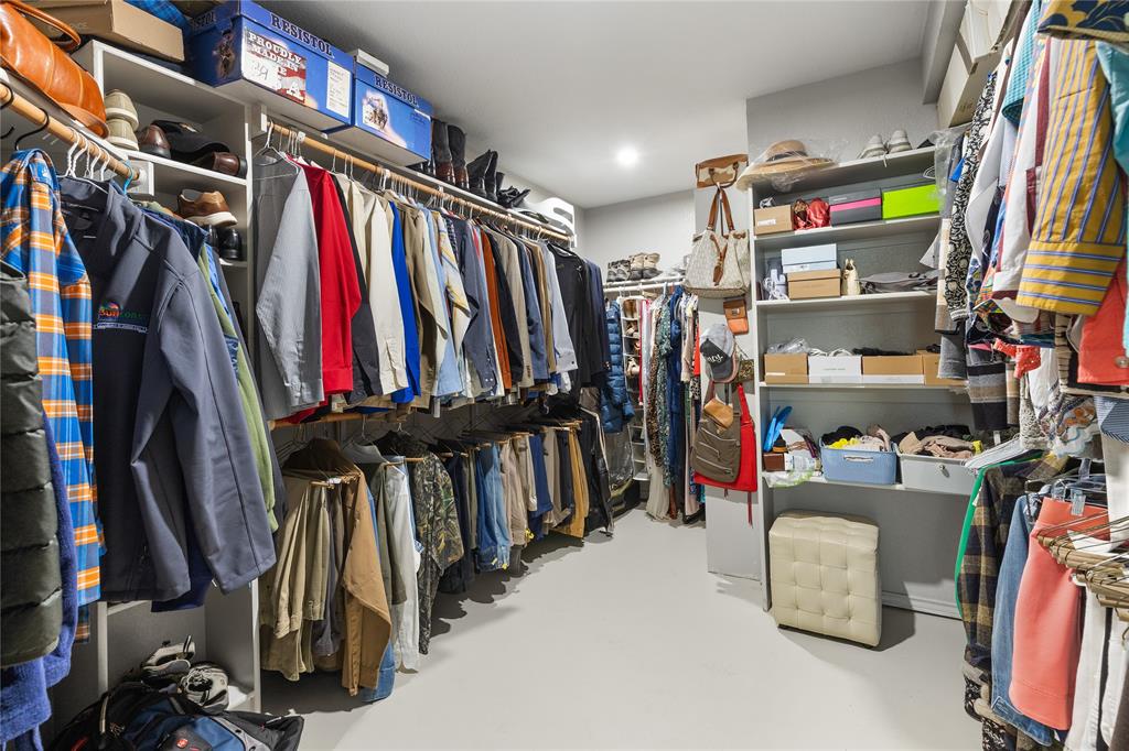 1007 Santa Fe Street Denton, TX 76205 - Photo 20 of 37 a view of walk in closet with clothes and shoes