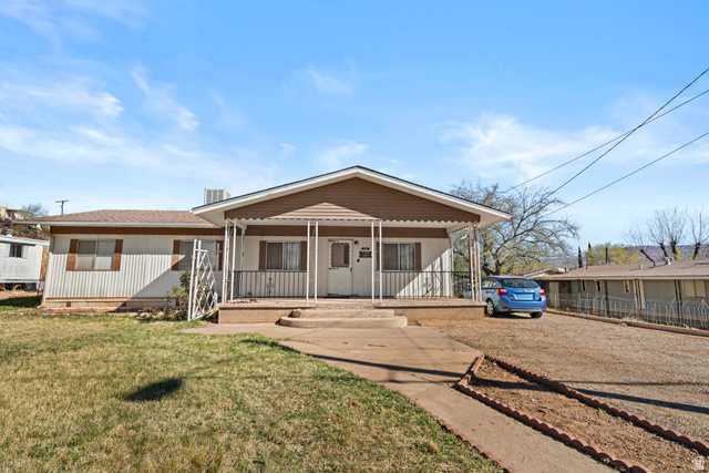 49 600 North Hurricane, UT 84737 - Photo 25 of 33 View of front of house with covered porch, a front yard, and crawl space