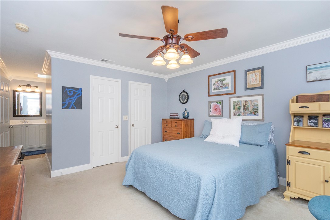203 Oak Hollow Pendleton, SC 29670 - Photo 32 of 50 Comfortable bedroom features carpet flooring and crown molding, with a ceiling fan providing ambient air circulation.
