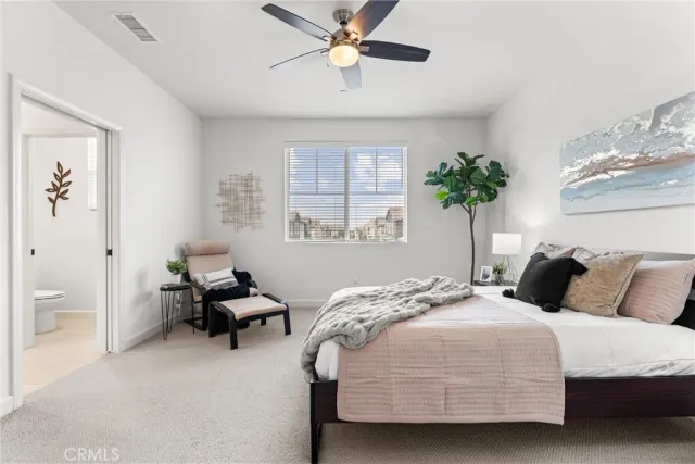 a bedroom that has a bed and a chandelier