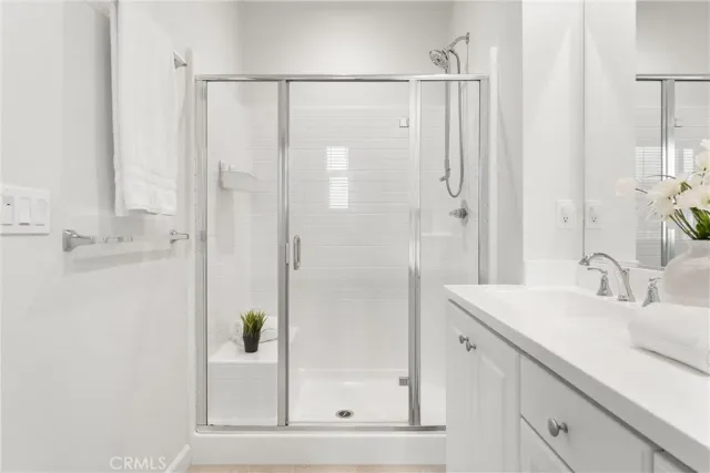 a spacious bedroom with a bed and a chandelier
