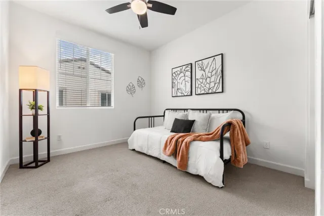 a bedroom with a bed and a window