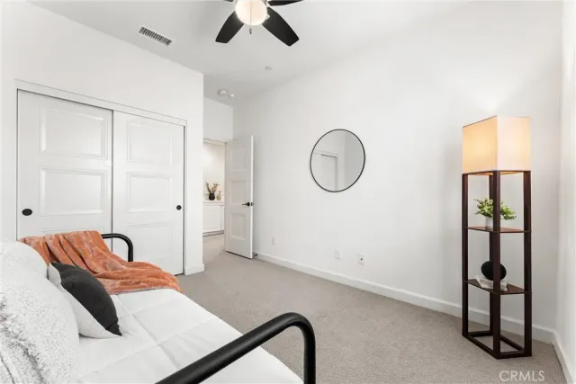 a bedroom with a bed and a lamp