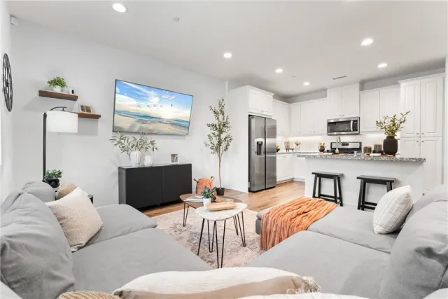 a living room kitchen with furniture and kitchen view