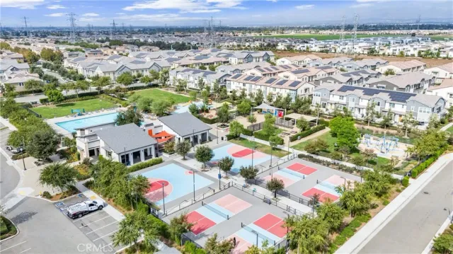 a view of a white house with large windows and a small yard