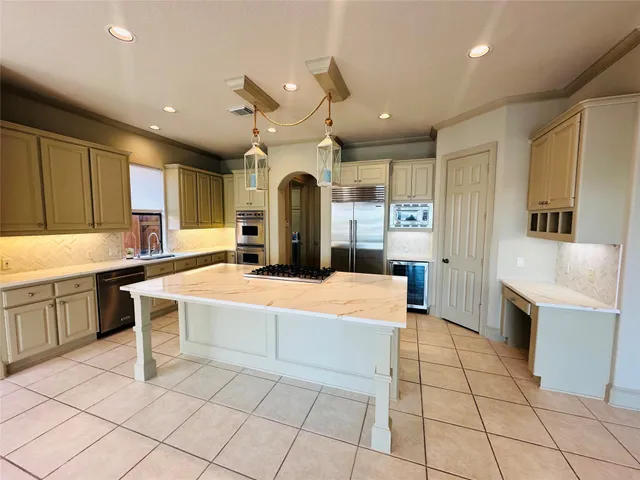 a large white kitchen with a large window