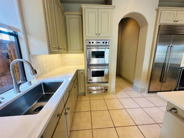 a kitchen with stainless steel appliances a stove a sink and a refrigerator