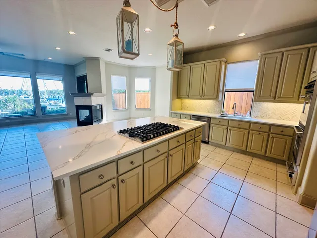 a kitchen with stainless steel appliances granite countertop a sink and a stove