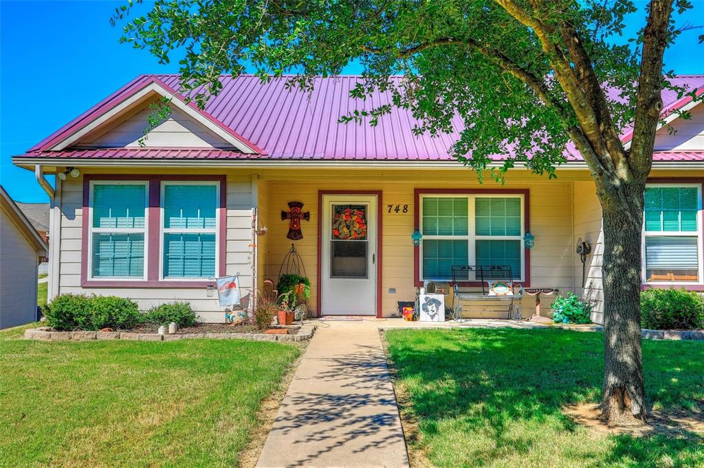 716 Rocky Ridge Flatts Oak Ridge, TX 76240 - Photo 2 of 10 a front view of a house with garden