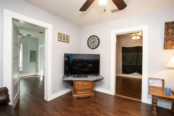 a living room with furniture a rug and a flat screen tv