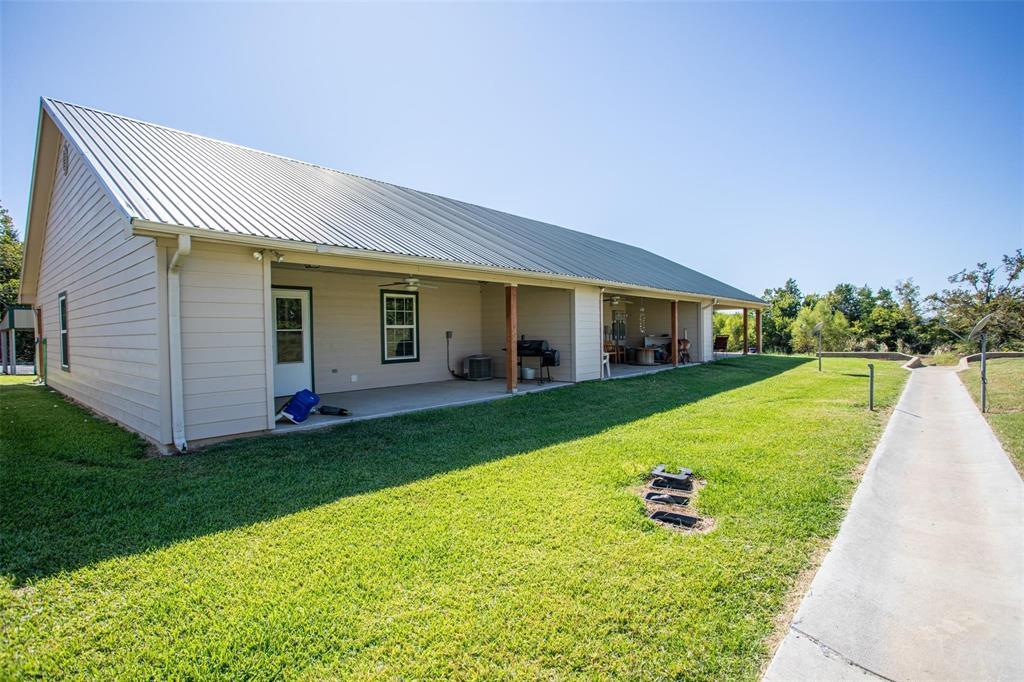 716 Rocky Ridge Flatts Oak Ridge, TX 76240 - Photo 8 of 10 a view of a house with a backyard