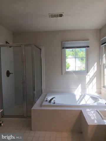 a bath tub sitting in a bathroom next to a window