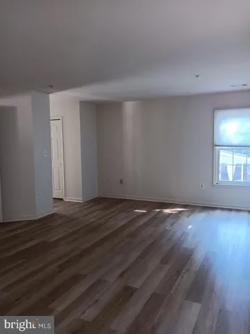 a view of an empty room and wooden floor