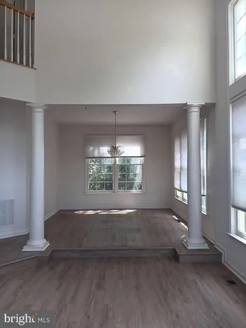 an empty room with windows and entrance