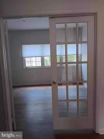 a view of an empty room with glass door