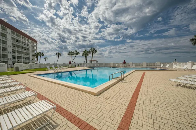 a view of a swimming pool with a patio