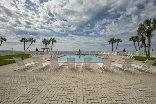 a view of a swimming pool with outdoor seating