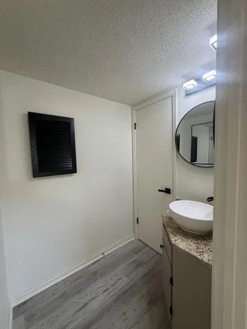a bathroom with a sink a toilet and mirror