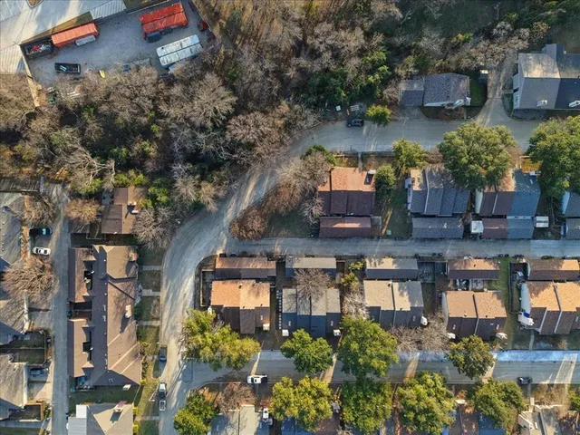 an aerial view of multiple houses with yard