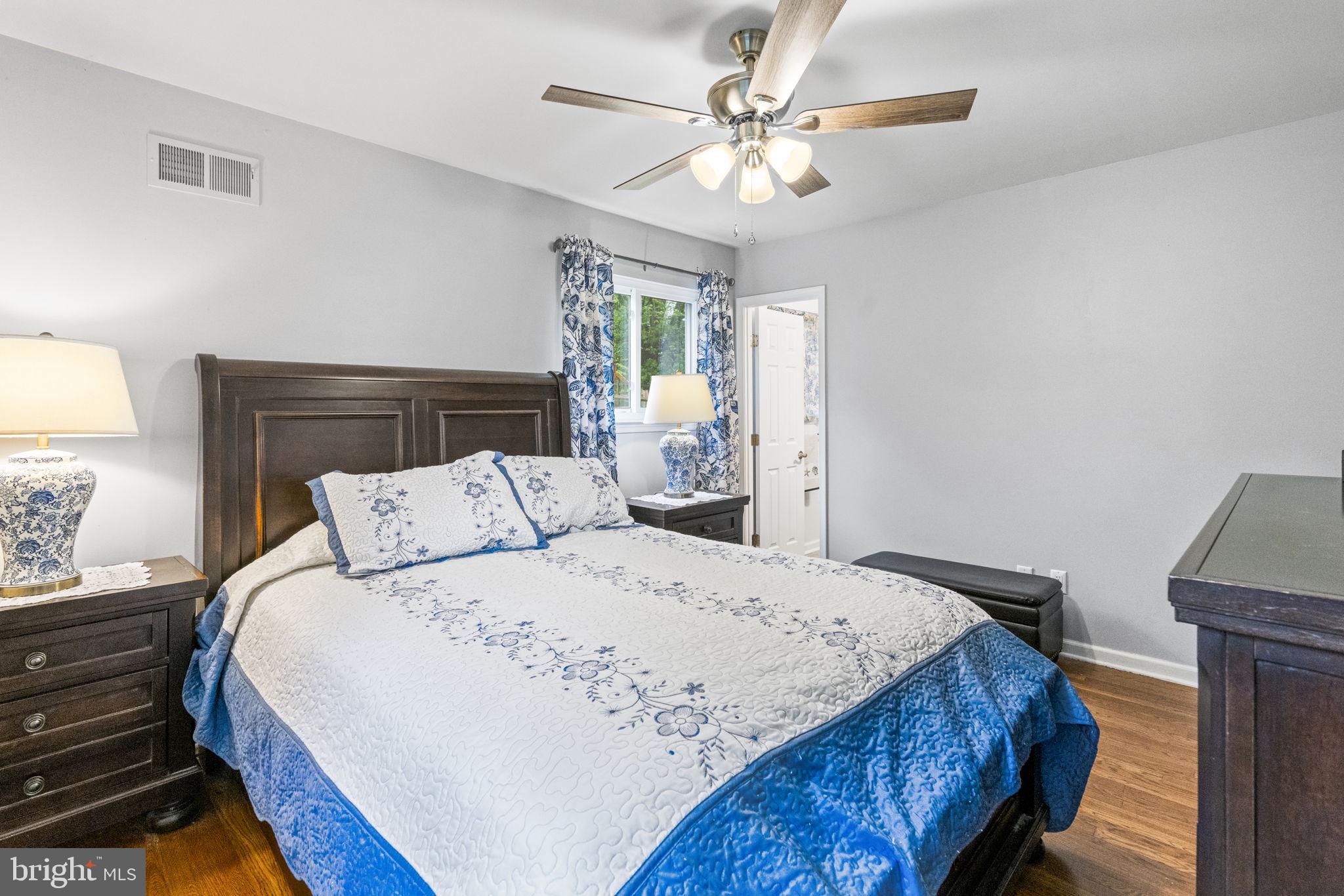 3019 Appledale Road Eagleville, PA 19403 - Photo 20 of 36 a bedroom with a bed a chandelier and a window