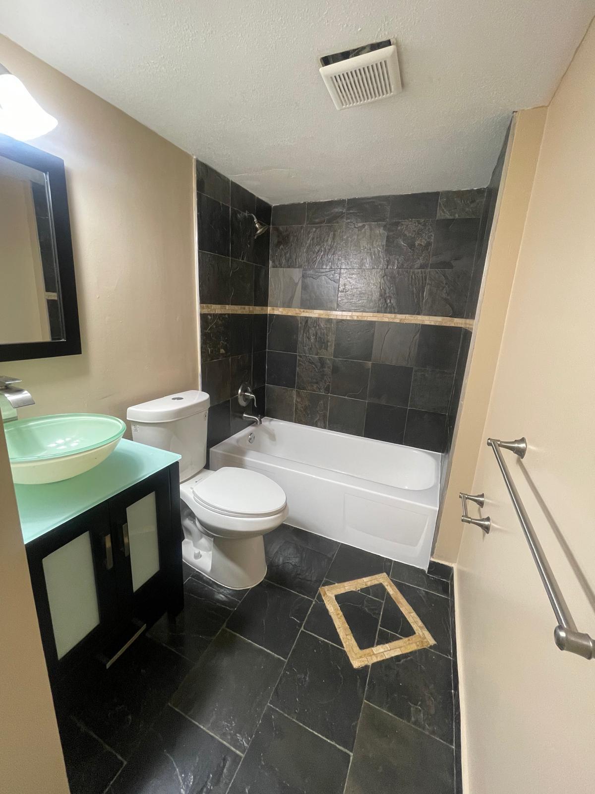 4156 Inverrary Drive, Unit 202 Lauderhill, FL 33319 - Photo 12 of 14 a bathroom with a toilet a sink and a mirror