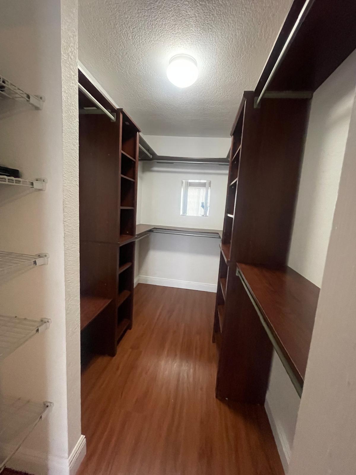 4156 Inverrary Drive, Unit 202 Lauderhill, FL 33319 - Photo 3 of 14 a view of walk in closet with wooden floor and stairs