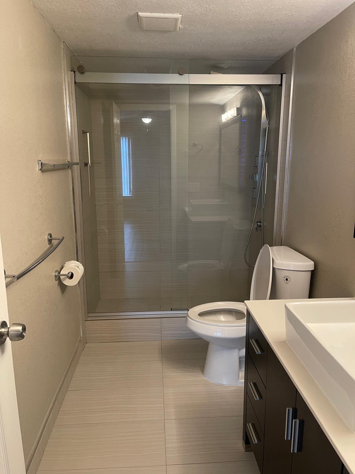 4156 Inverrary Drive, Unit 202 Lauderhill, FL 33319 - Photo 6 of 14 a bathroom with a toilet sink and shower