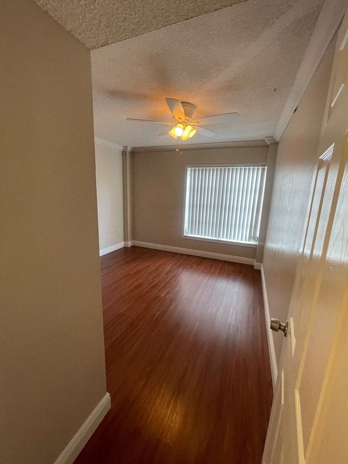 4156 Inverrary Drive, Unit 202 Lauderhill, FL 33319 - Photo 9 of 14 wooden floor in an empty room with a window