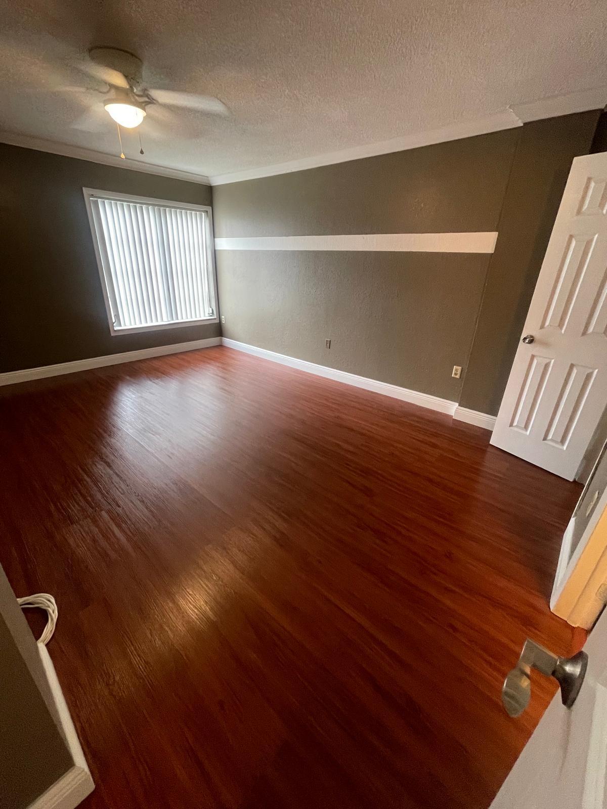 4156 Inverrary Drive, Unit 202 Lauderhill, FL 33319 - Photo 10 of 14 a view of an empty room with wooden floor and a window