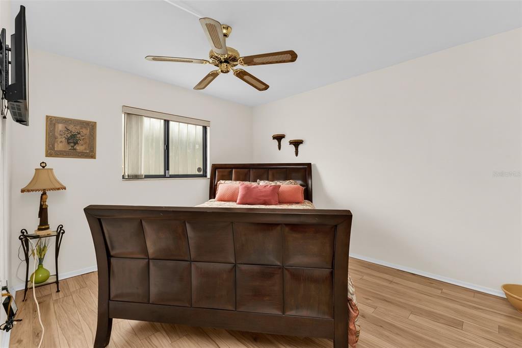 25225 Rampart Boulevard, Unit 1604 Punta Gorda, FL 33983 - Photo 16 of 41 a bedroom with a bed and wooden floor