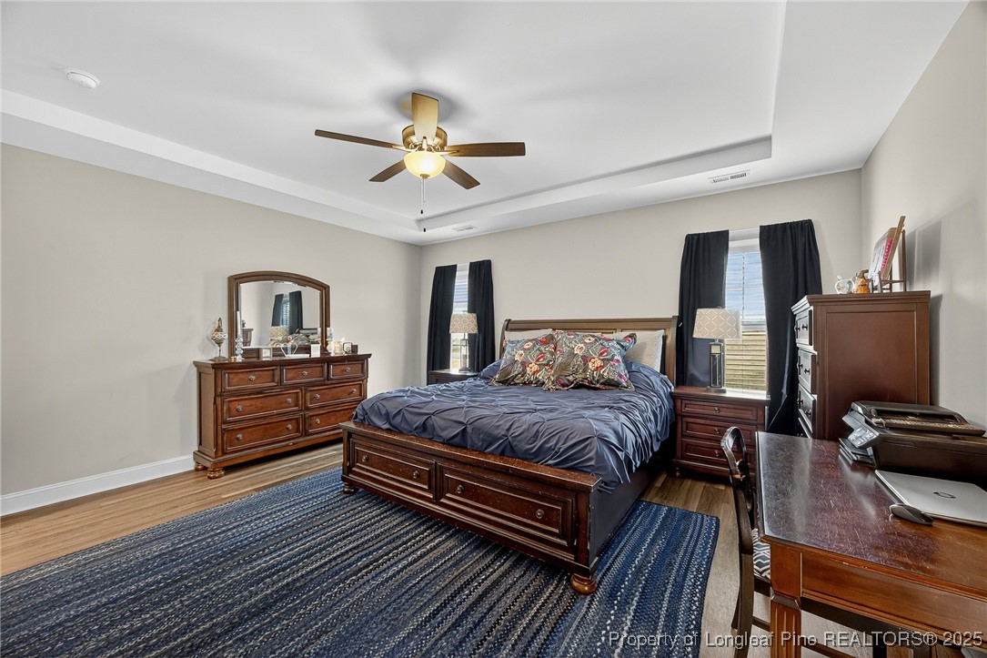 193 Rocking Horse Lane Raeford, NC 28376 - Photo 13 of 25 a bedroom with a bed and wooden floor