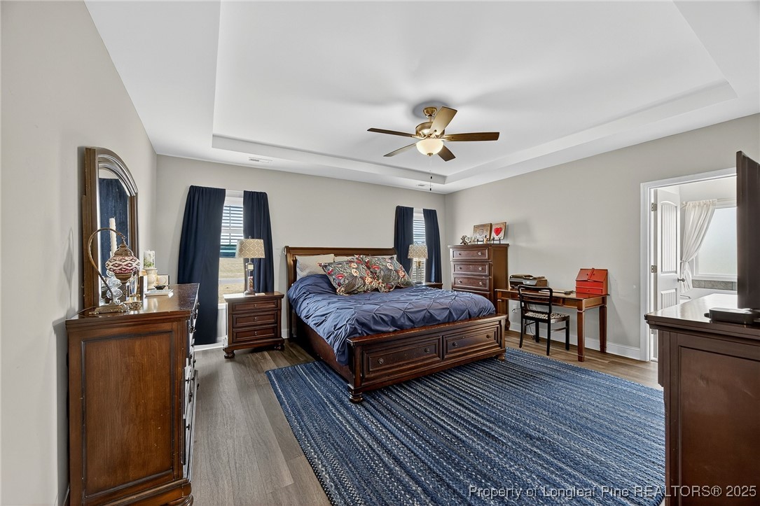 193 Rocking Horse Lane Raeford, NC 28376 - Photo 14 of 25 a bedroom with a bed and a chandelier