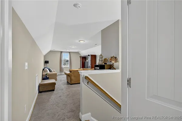 a living room with furniture and cars