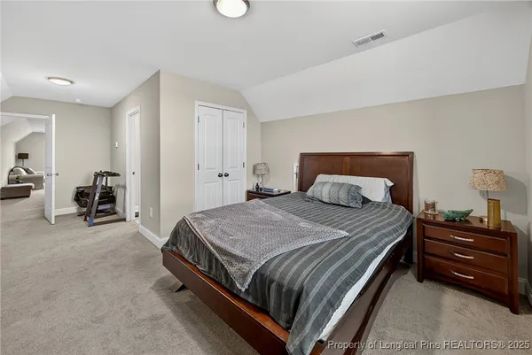 a bedroom with a bed and a view of chair
