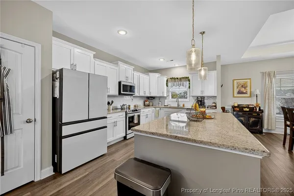 a kitchen with refrigerator a sink and cabinets