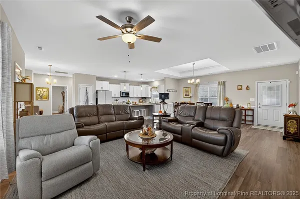a living room with furniture a lamp and a chandelier