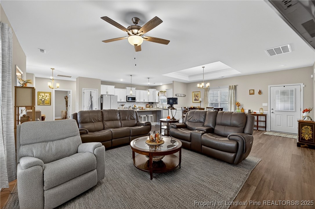 193 Rocking Horse Lane Raeford, NC 28376 - Photo 8 of 25 a living room with furniture a lamp and a chandelier