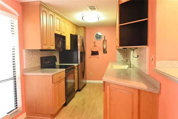 a kitchen with a sink a stove and a refrigerator