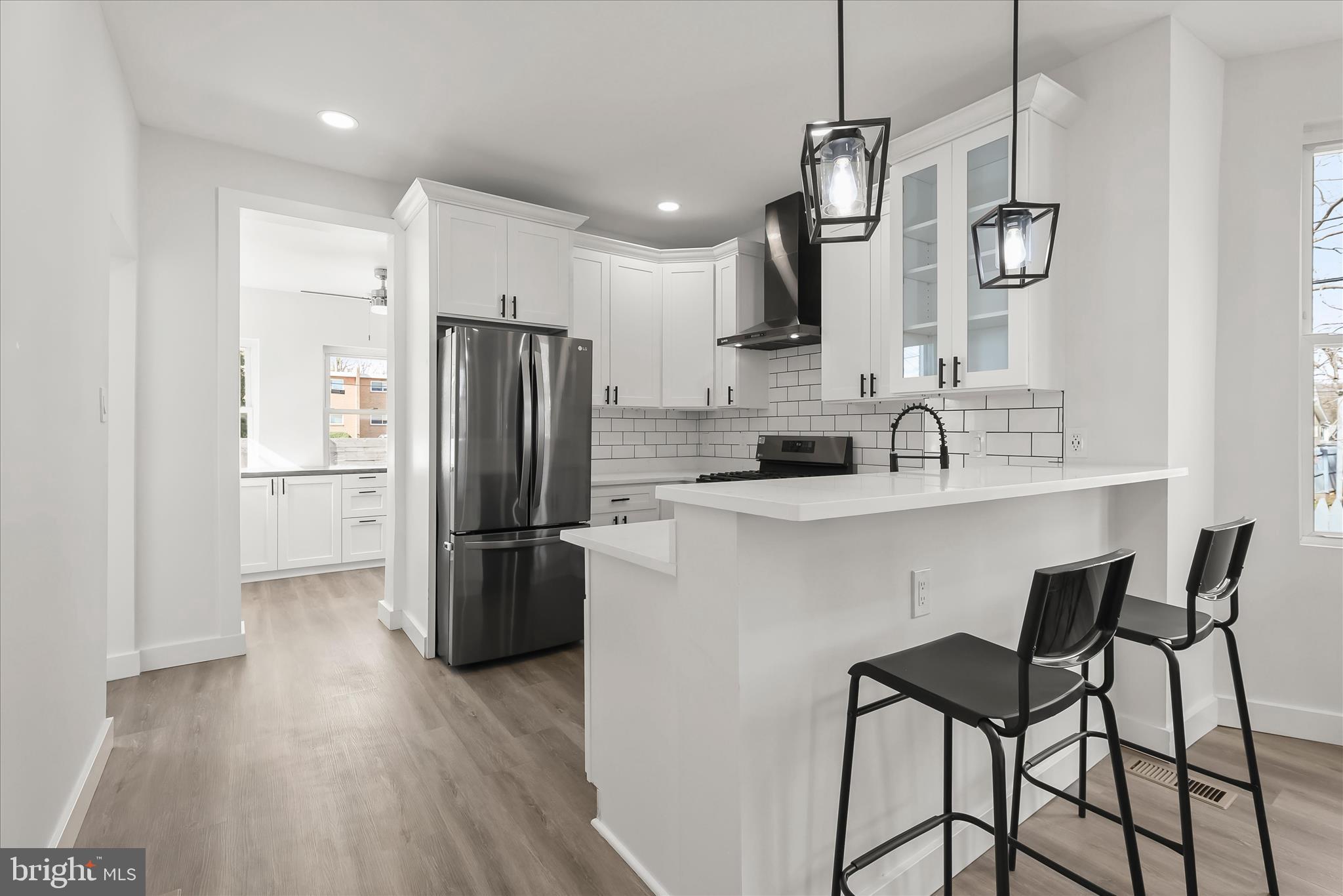 5822 Ethelbert Avenue Baltimore, MD 21215 - Photo 13 of 37 a kitchen with refrigerator and chairs
