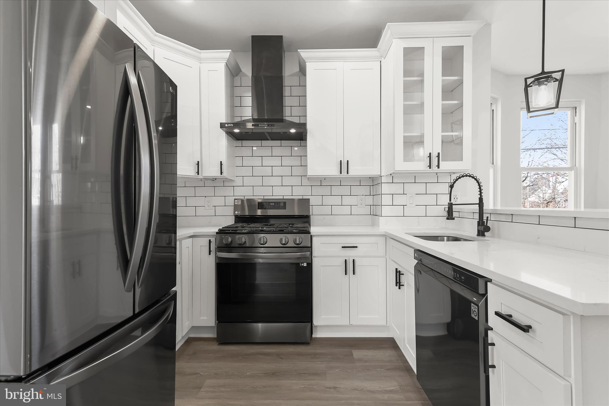 5822 Ethelbert Avenue Baltimore, MD 21215 - Photo 14 of 37 a kitchen with stainless steel appliances a sink cabinets and a refrigerator