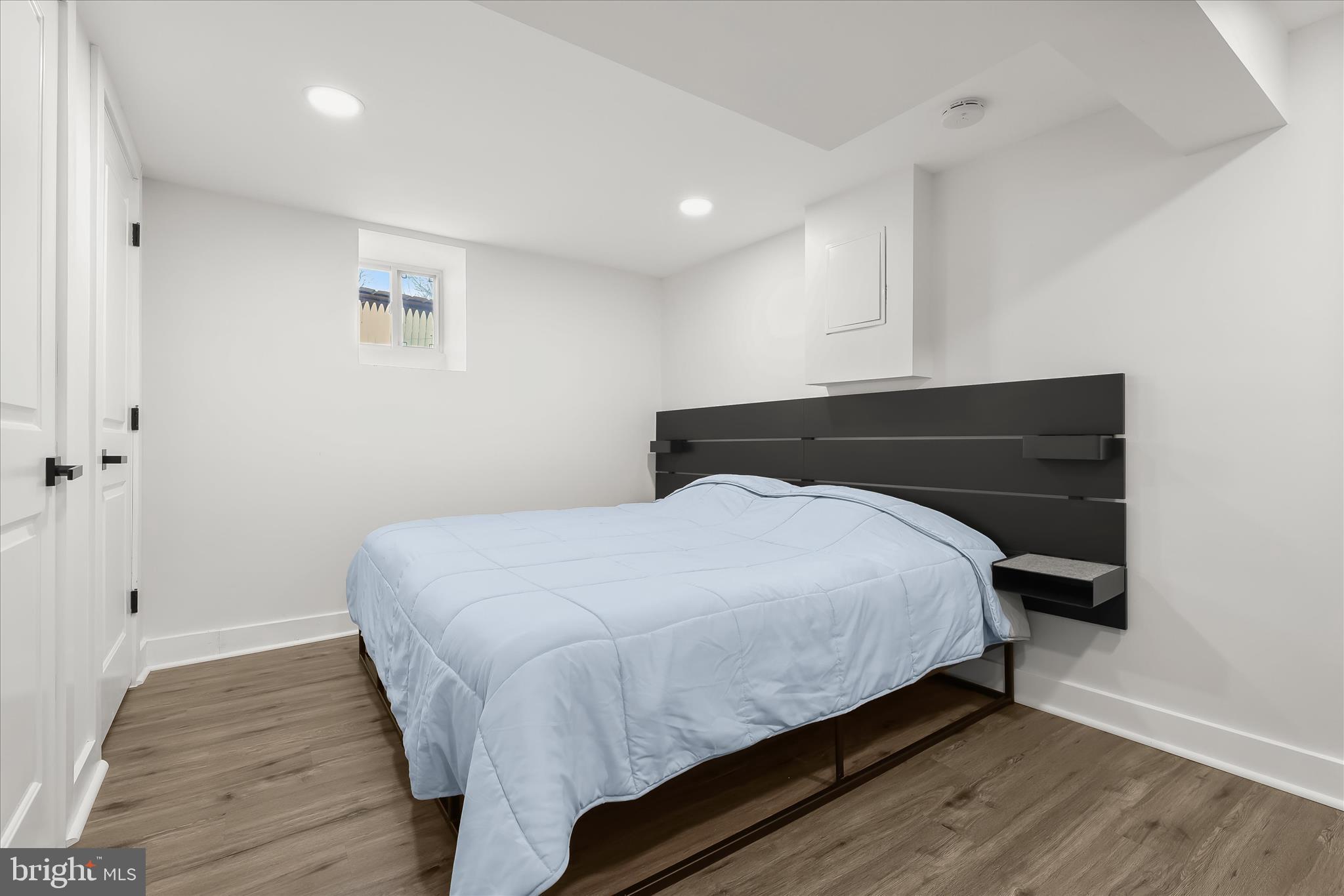 5822 Ethelbert Avenue Baltimore, MD 21215 - Photo 30 of 37 a bedroom with a bed and a table