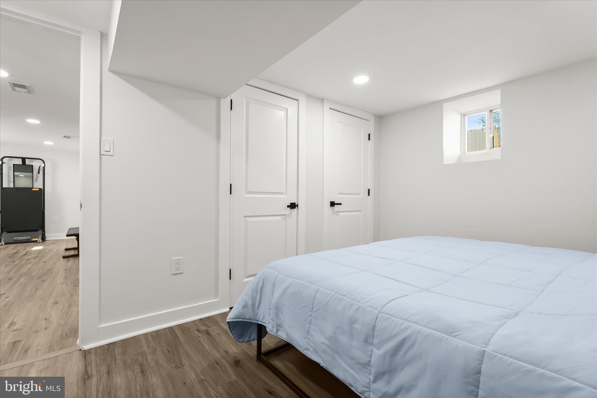 5822 Ethelbert Avenue Baltimore, MD 21215 - Photo 31 of 37 a spacious bedroom with a bed and a wooden floor